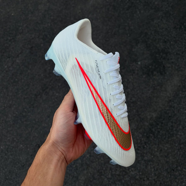 Mercurial football boot featuring a textured gold and red-outlined Swoosh from the Break 'Em pack