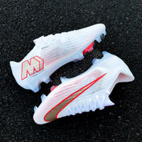 Mercurial football boot featuring a textured gold and red-outlined Swoosh from the Break 'Em pack